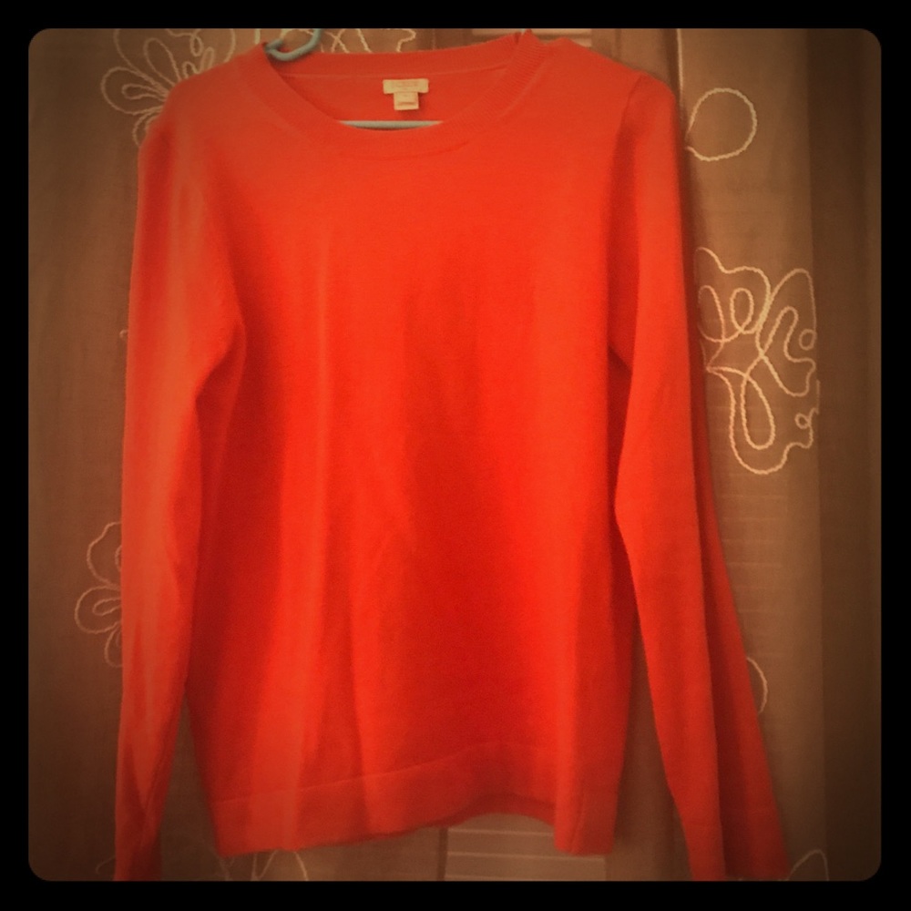 A JCREW Women’s sweater in bright red. Size M